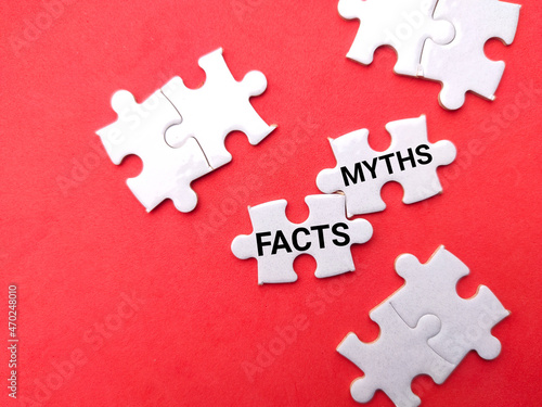 White puzzle with text FACTS MYTHS on a red background. photo