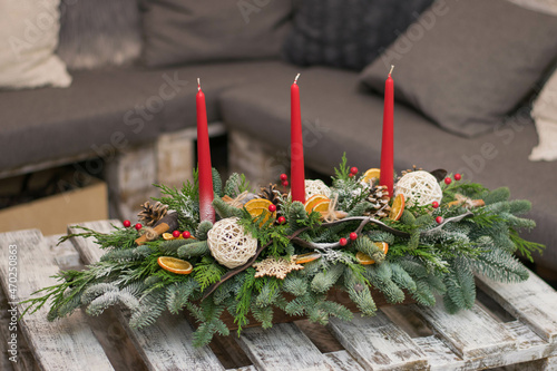 Christmas table decoration with candles, globes and cones photo