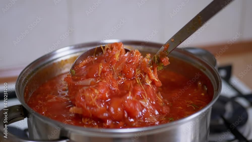 Preparing Rich, Thick, Red Borscht from Meat, Beet in a Saucepan in Home Kitchen. Vegetarian food made from vegetables, potatoes, carrots. Traditional, national food of Ukrainian and Russian cuisine. Preparing Rich, Thick, Red Borscht from Meat, Beet in a Saucepan in Home Kitchen. Vegetarian food made from vegetables, potatoes, carrots. Traditional, national food of Ukrainian and Russian cuisine.