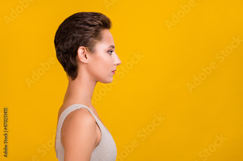 Profile photo of focused concentrated lady look empty space wear grey top isolated yellow color background