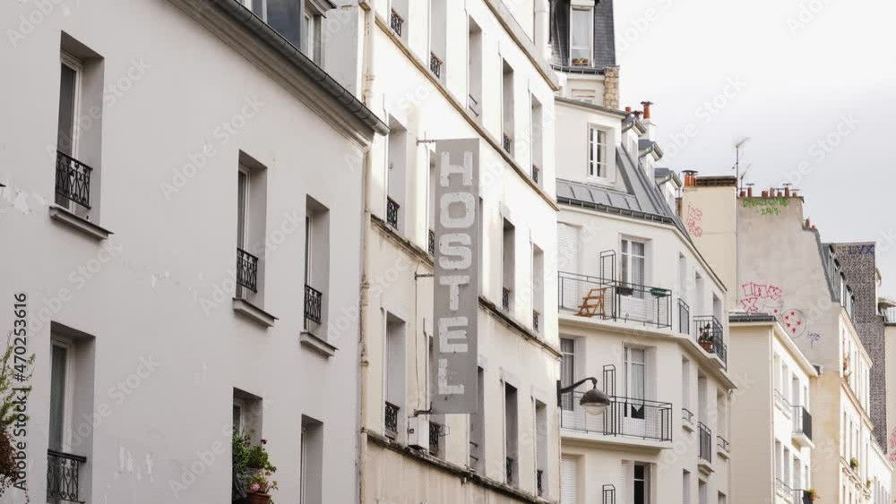 Paris hostel vertical signboard on a building facade in beautiful city center Paris hostel vertical signboard on a building facade in beautiful city center
