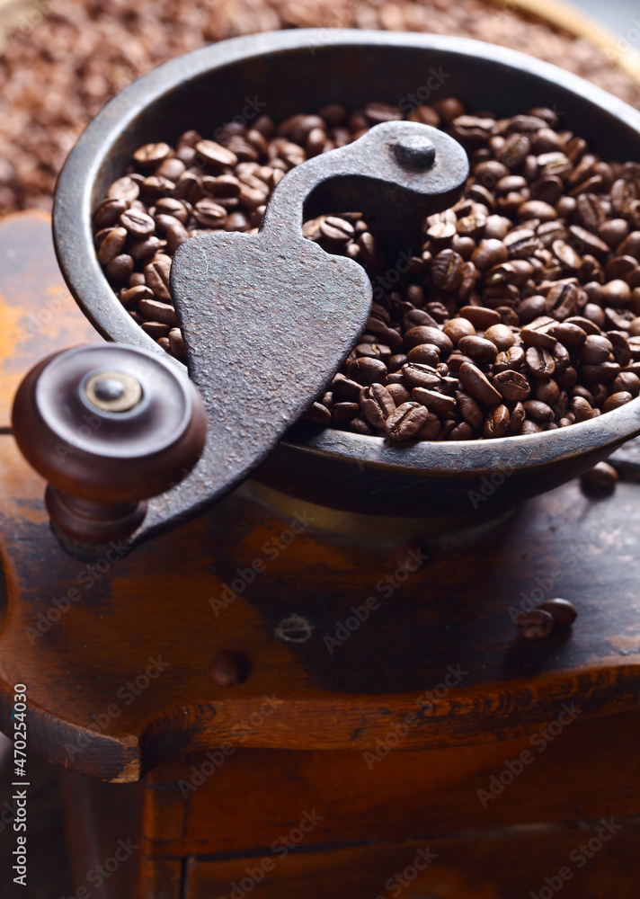 close-up of old coffee grinder and roasted coffee beans close-up of old coffee grinder and roasted coffee beans