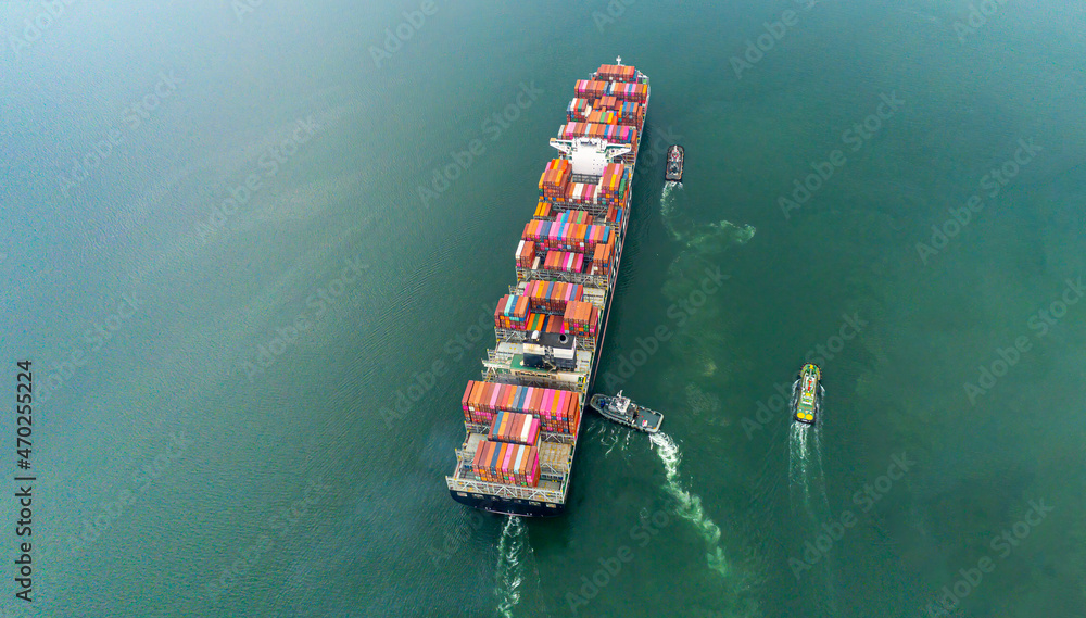 Aerial top view containers ship cargo business commercial trade logistic and transportation of international import export by container frieght cargo ship in the open seaport.