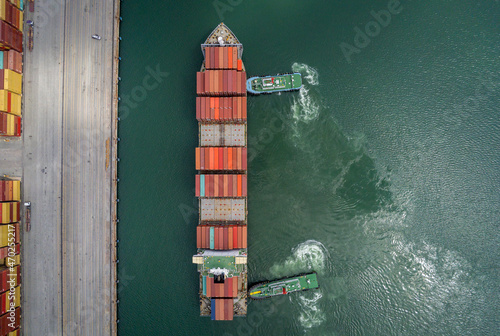 Aerial top view containers ship cargo business commercial trade logistic and transportation of international import export by container frieght cargo ship in the open seaport. © APchanel