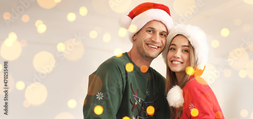 Happy young couple in Santa...