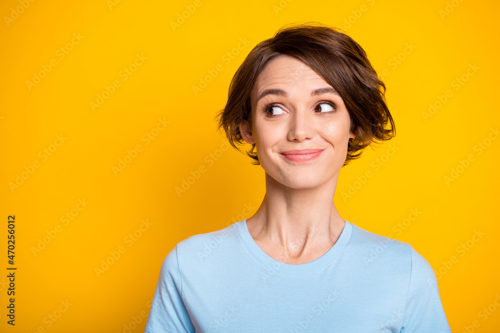 Photo of young attractive girl happy positive smile dream dreamy look empty space isolated over yellow color background Photo of young attractive girl happy positive smile dream dreamy look empty space isolated over yellow color background