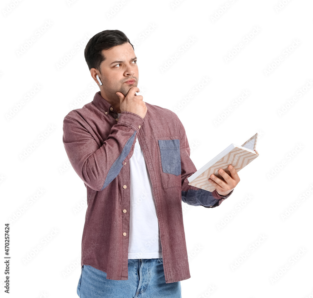 Thoughtful man with book and earphones on white background Thoughtful man with book and earphones on white background
