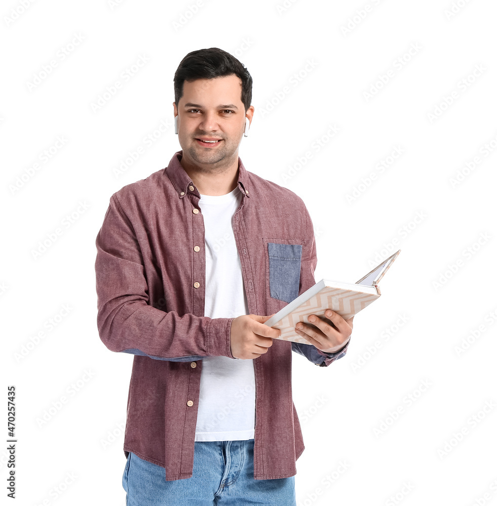 Young man with book and earphones on white background Young man with book and earphones on white background