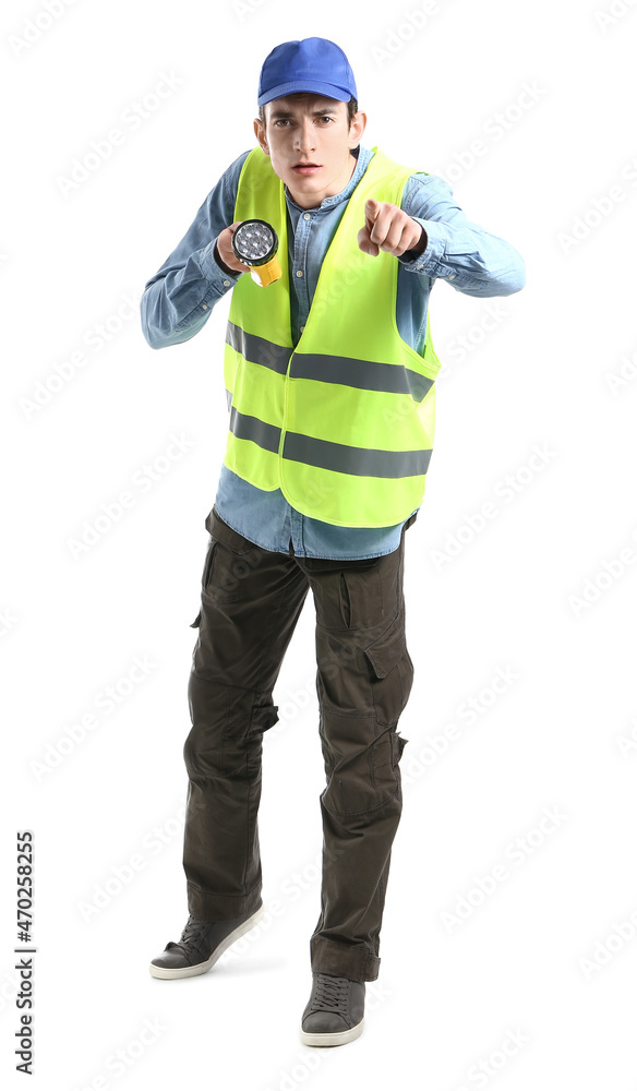 Young male worker with LED flashlight pointing at viewer on white background Young male worker with LED flashlight pointing at viewer on white background