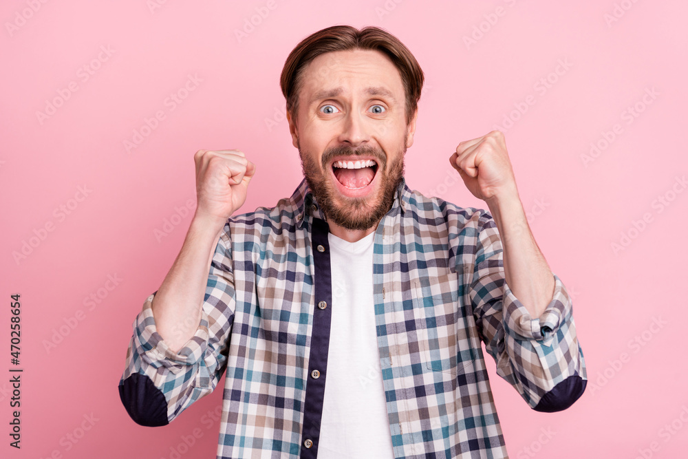 Naklejka premium Photo of young man happy positive smile rejoice victory champion goal fists hands isolated over pink color background