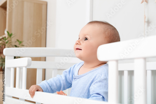 Cute little baby boy in crib