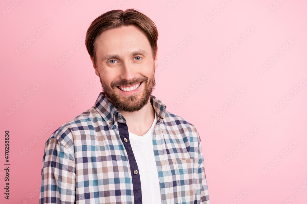 Photo of young cheerful man happy positive smile wear plaid shirt isolated over pink color background Photo of young cheerful man happy positive smile wear plaid shirt isolated over pink color background