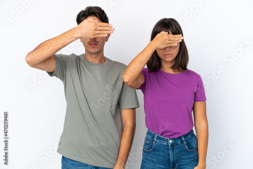 Young couple isolated on isolated white background covering eyes by hands. Do not want to see something