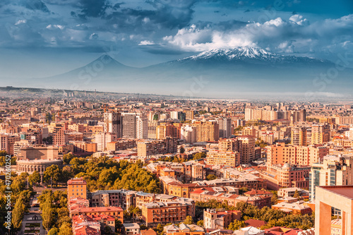 Fényképezés Spectacular aerial view of the buildings roofs of the city of Yerevan and the snow caps of Mount Ararat