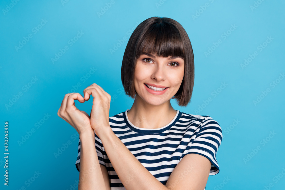 Photo of charming happy affectionate woman hold fingers heart shape isolated on pastel blue color background Photo of charming happy affectionate woman hold fingers heart shape isolated on pastel blue color background