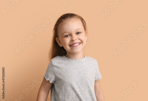 Portrait of happy little girl on color background