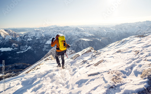 Beautiful amazing day winter mountains. A man goes a sport hike in snow holidays. Nature background