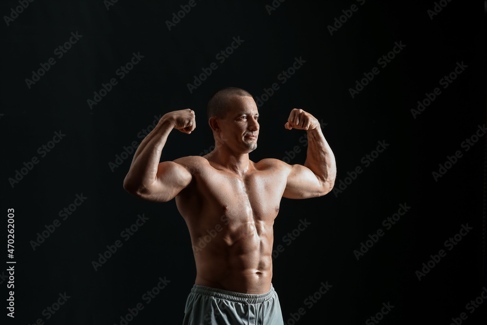 Male bodybuilder on dark background