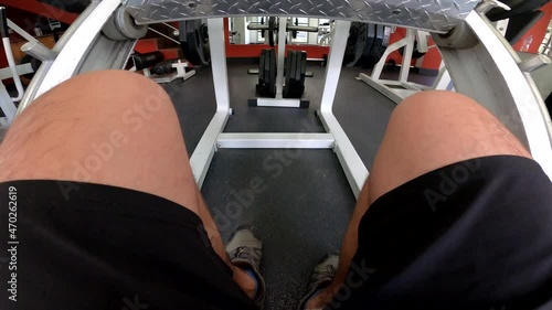 pov first view sitting on a gym machine on the leg press with his friend