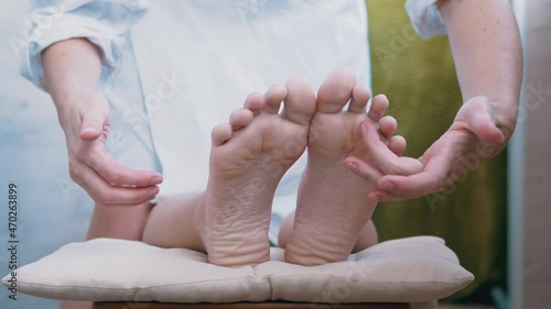 Female Hands Tickling, Massaging Bare Legs, Feet of a Child. Wiggling toes. Pressing acupuncture points of foot with fingers. Reflex massage. Effective treatment, improves blood circulation in soles.