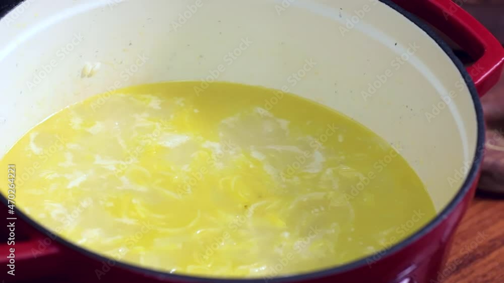 Preparing food. Stirring with a wooden spoon inside the pan. Preparing food. Stirring with a wooden spoon inside the pan.