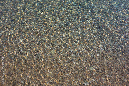 Pebble stones transparent sea water background