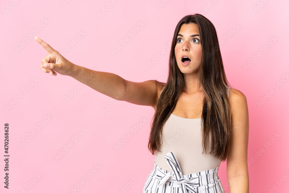 Young brazilian woman isolated on pink background pointing away Young brazilian woman isolated on pink background pointing away