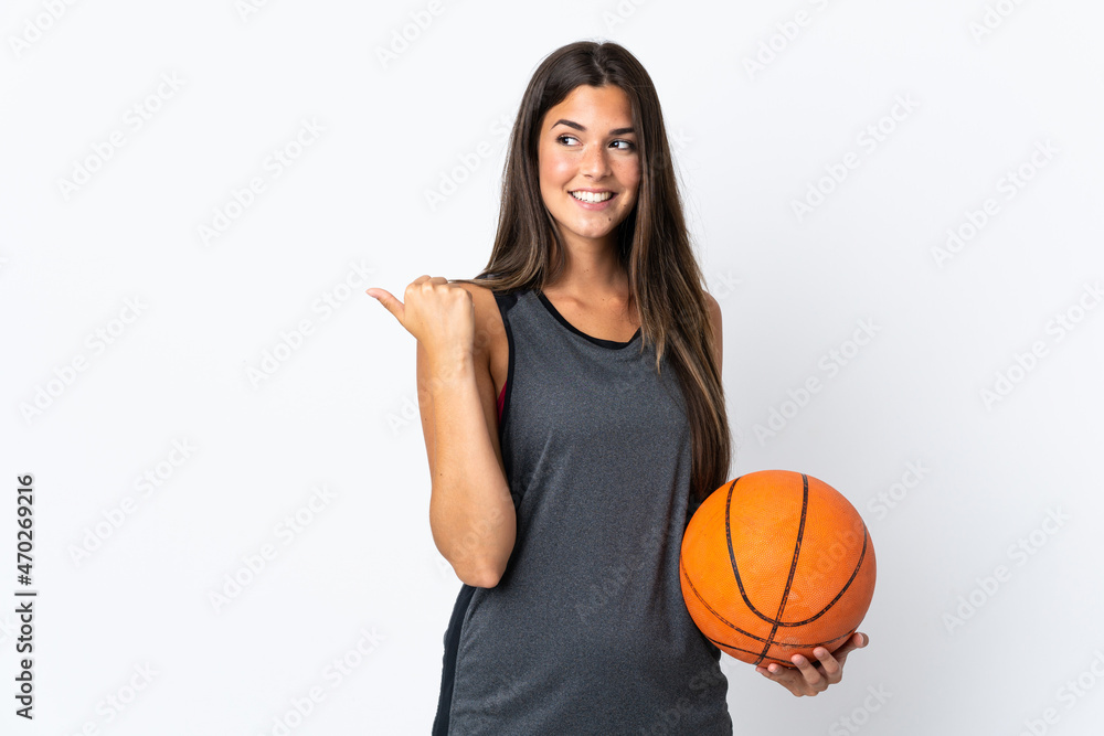 Young brazilian woman playing basketball isolated on white background pointing to the side to present a product Young brazilian woman playing basketball isolated on white background pointing to the side to present a product
