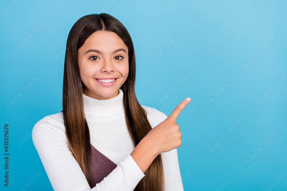 Photo of young pretty girl point finger empty space decision advert choose isolated over blue color background Photo of young pretty girl point finger empty space decision advert choose isolated over blue color background