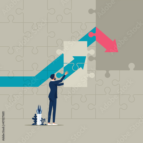Businessman holding puzzles to assembly change situation from graph down to growing graph, increase business profits and change direction of financial 