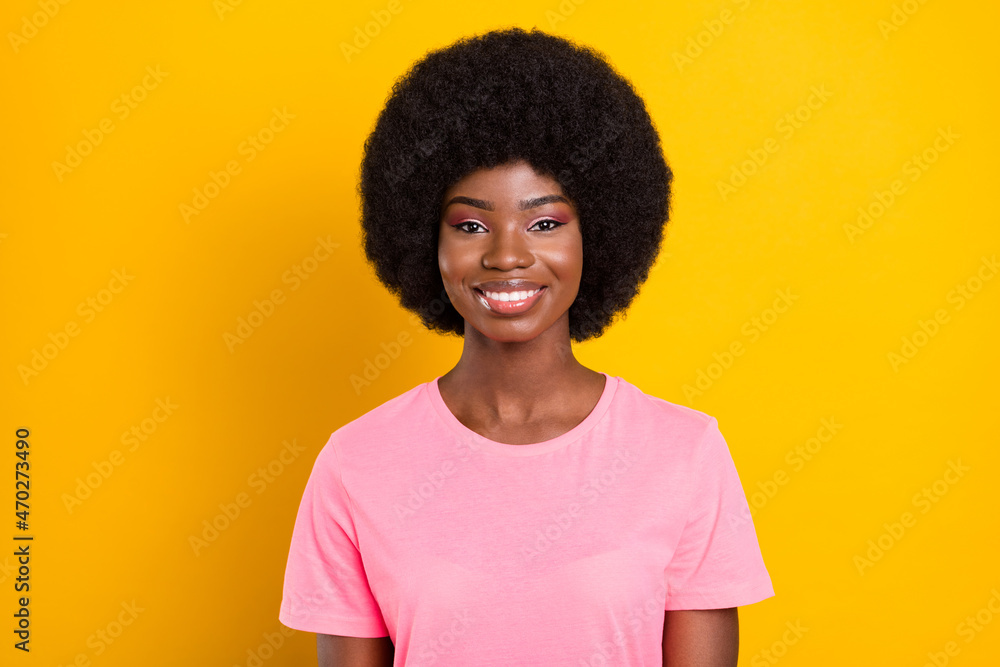 Photo of young attractive african girl happy positive toothy smile isolated over yellow color background Photo of young attractive african girl happy positive toothy smile isolated over yellow color background