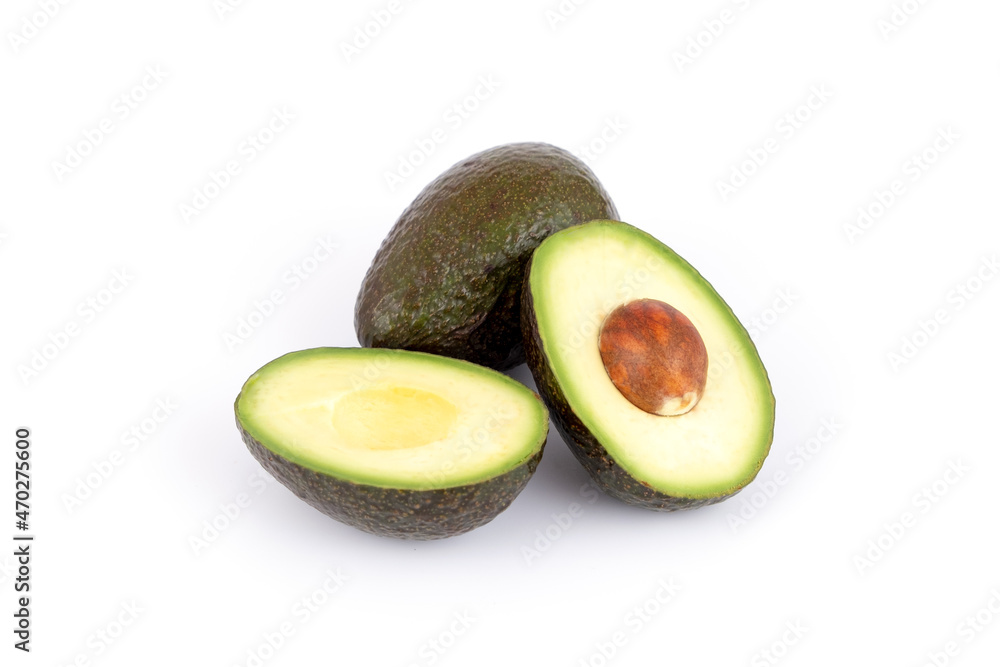Fresh and ripe avocado whole and cut in half, healthy fruit isolated
