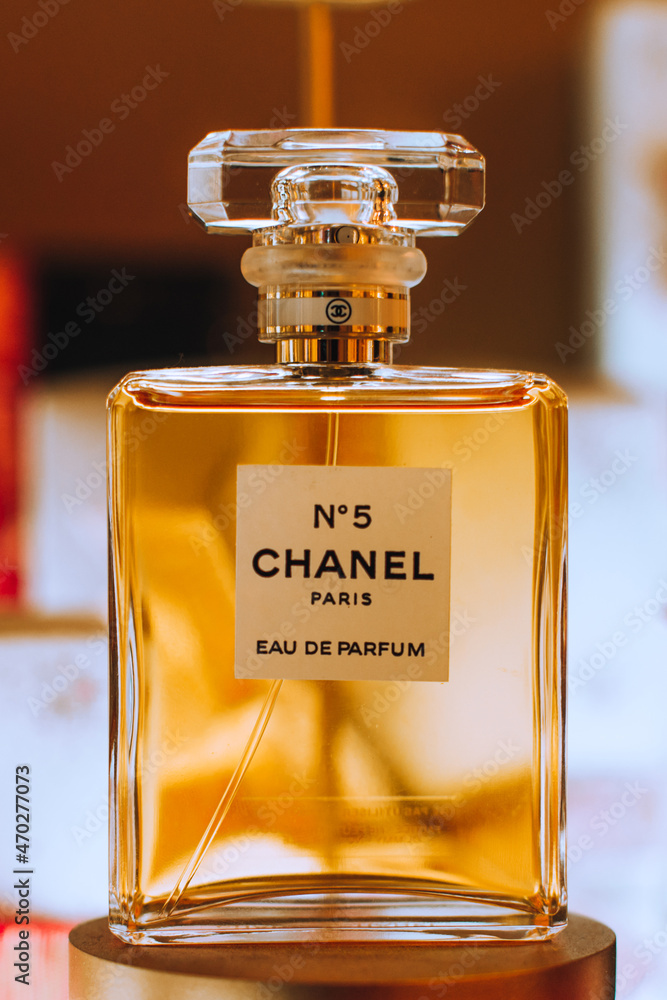 Display of golden bottle Chanel No. 5 perfume by French luxury brand  Chanel. Famous fragrance. Photos | Adobe Stock