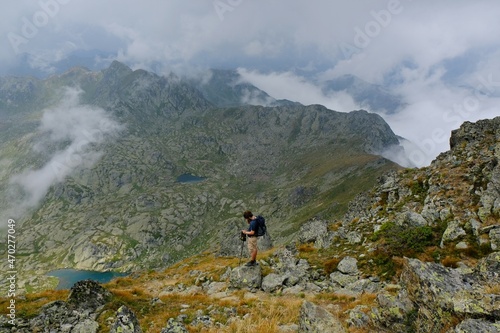Beautiful mountain view above clouds around peak Djeravica (Gjerovica) - highest peak of Kosovo. Silhouette of lonely tourist with backpack on trail. Albanian Alps, Peaks of Balkans © Iwona