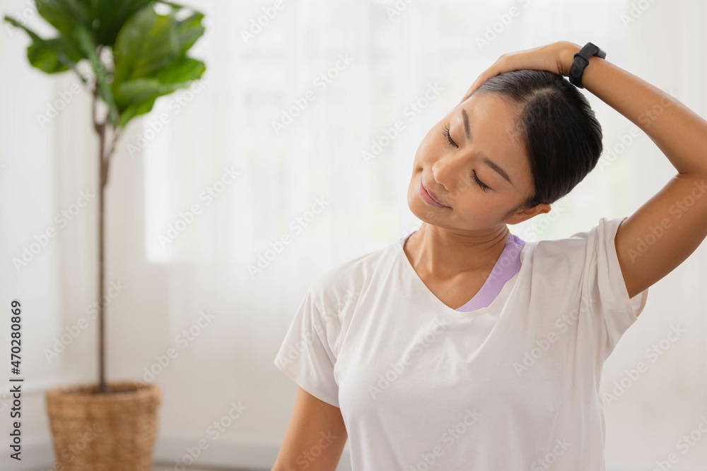 Asian woman exercises In the fitness studio, practice neck stretching and meditation for better health. Asian woman exercises In the fitness studio, practice neck stretching and meditation for better health.