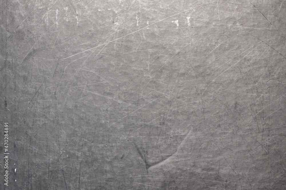 Naklejka premium The surface of a scratched sheet of metal, with dots, potholes and scratches. Uneven texture with lines, stripes and pattern.