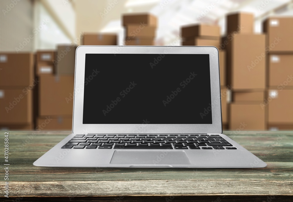 Laptop blank Screen for Infographics Displaying, Standing in Warehouse with boxes. Laptop blank Screen for Infographics Displaying, Standing in Warehouse with boxes.
