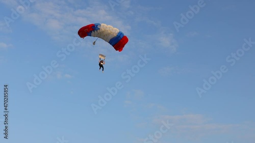 Ecka, Vojvodina, Serbia - August 21, 2021 National Parachuting Championship: Parachutist is flying slowly down with an open parachute. Skydiving, gliding, parachute jump