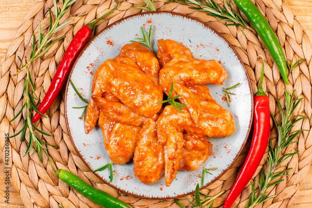 Oven baking wings. Chicken wings are raw in the marinade. Semifinished. Fast cooking.Raw Marinated chicken meat wings for BBQ,Cooking chicken with spices . Grilled chicken wings recipe.