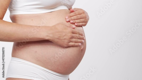 Wallpaper Mural Young, happy and healthy pregnant woman on white background. Studio video. Baby expectation, pregnancy and motherhood concept. Torontodigital.ca