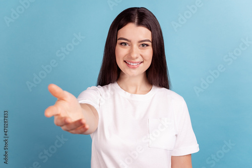 Photo of young charming cheerful girl good mood give arm ask invite isolated over blue color background