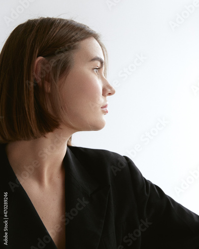 Business woman in the studio drinks wine and eat croissants 