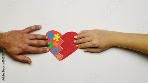 Wallpaper Mural The couple reunites the two halves of the heart with the image of puzzles on one part. A symbol of support for people with autism syndrome. World Autism Awareness Day Torontodigital.ca