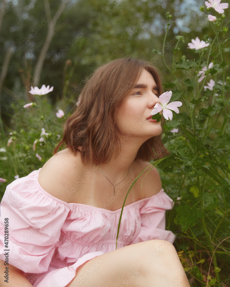 Smiling woman on the nature with flowers in dress Smiling woman on the nature with flowers in dress