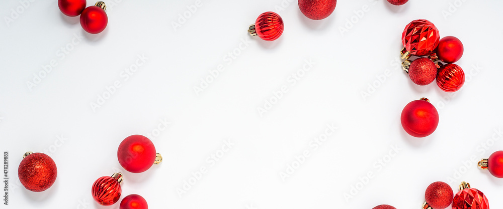Decorative red balls on a white background. Top view, flat lay. Banner. Decorative red balls on a white background. Top view, flat lay. Banner.