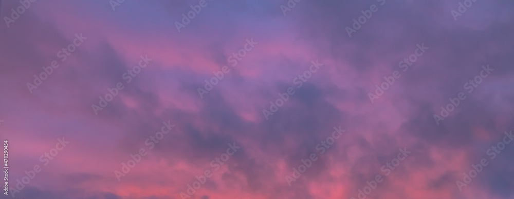 Pink purple twilight sky with dark light clouds