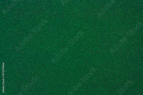 Green texture with roughness. Green background. Artificial turf.
