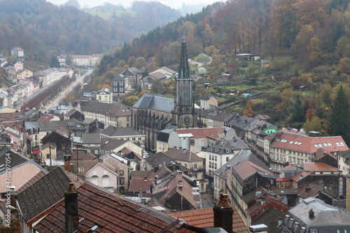 View of the historic spa town of Plombières-les-bains, in Vosges, France, on a misty autumn day. High angle view from the surrounding hillsides.