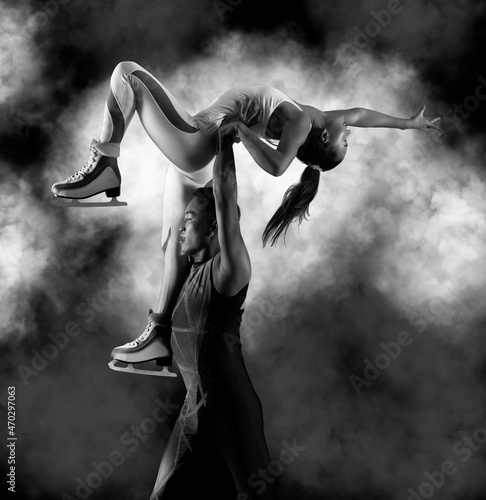 Fotografiet Lift. Duo figure skating in action on black background