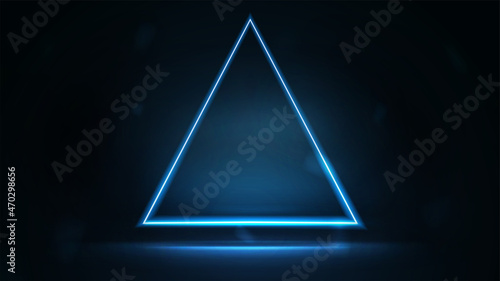 Neon triangular frame on dark background. Blue digital hologram neon triangle border with copy space in dark room.